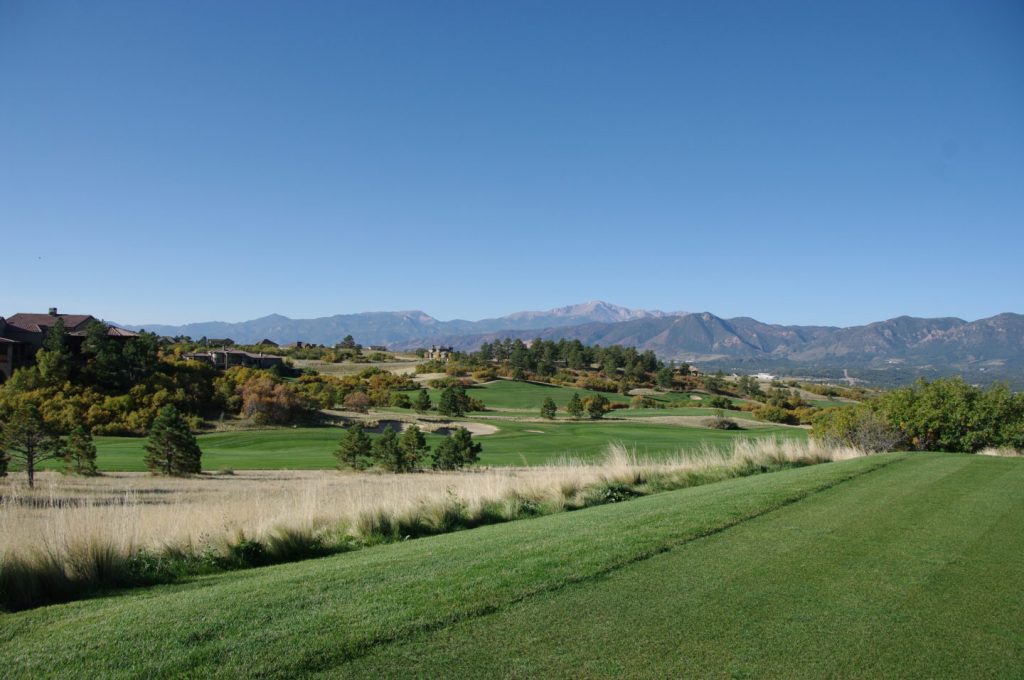 Golf course green with mountains in distance