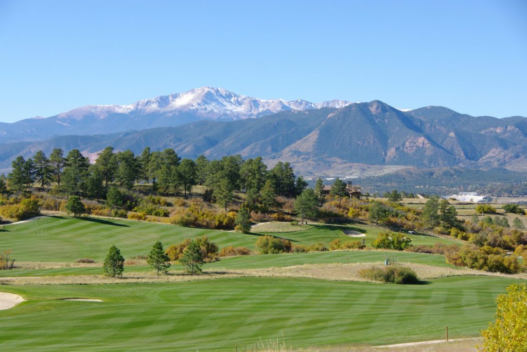 Mountains overlooking manicured golf course green