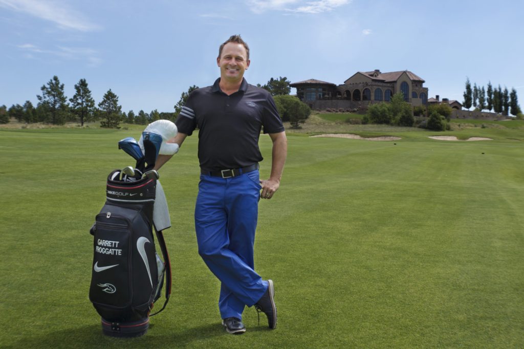 Garrett with clubs on golf course