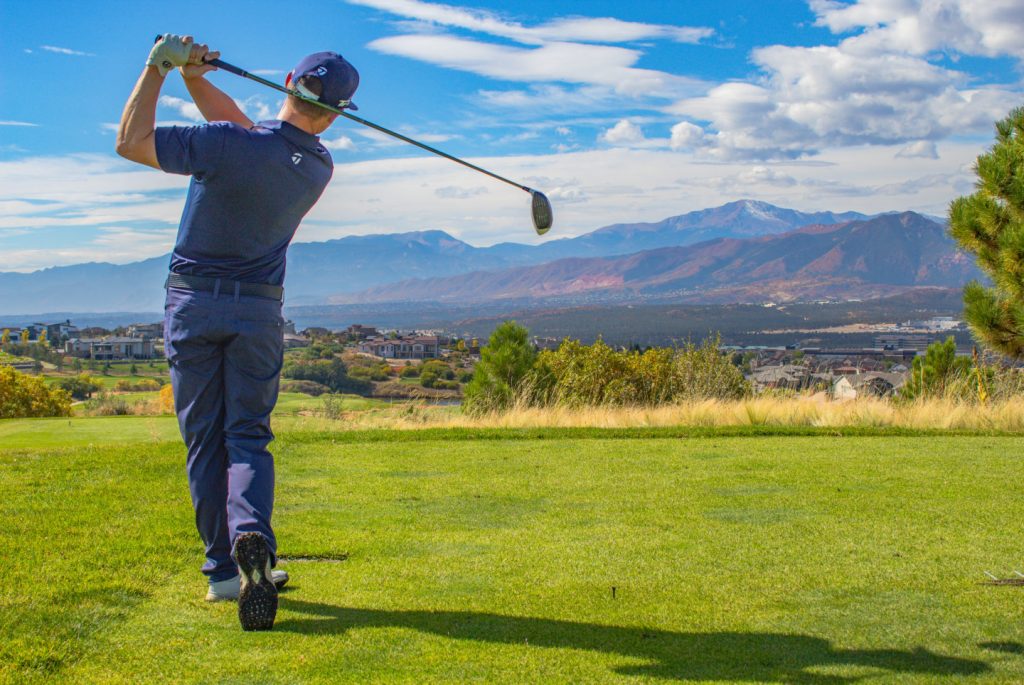 golf course instructor taking swing