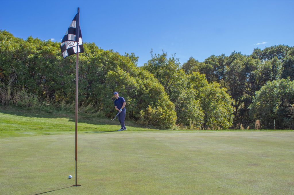 Golf course instructor with flag